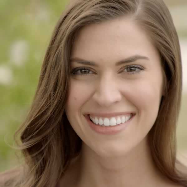 A Woman smiling showing white teeth