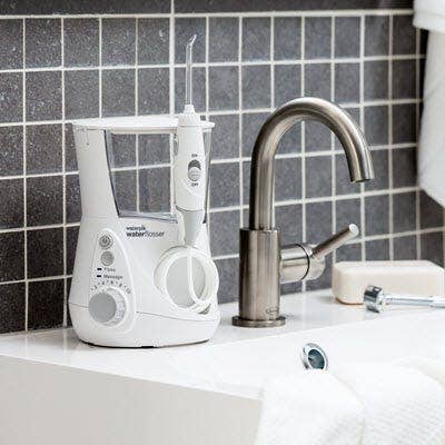 Countertop water flosser sitting on sink